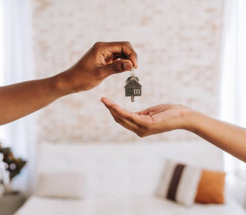 Real estate agent giving a man the keys to his new home